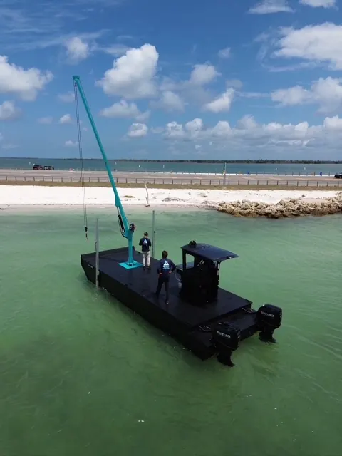 Beach Landing — Spuds down at a Gulf-coast beach | HDPE work barge for sale, Fort Myers, FL
